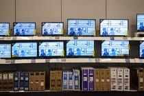 A photograph of rows of televisions in a Best Buy