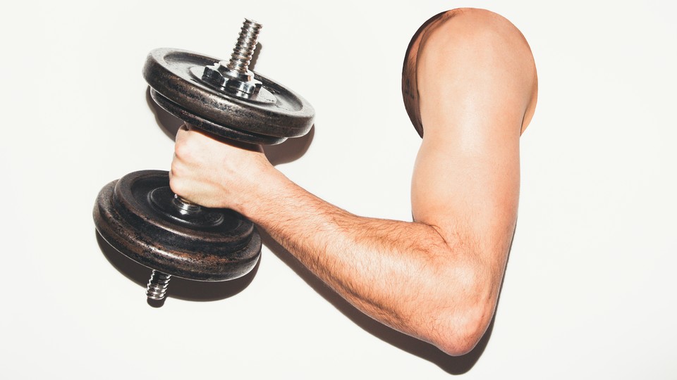 A man's arm holding a dumbbell