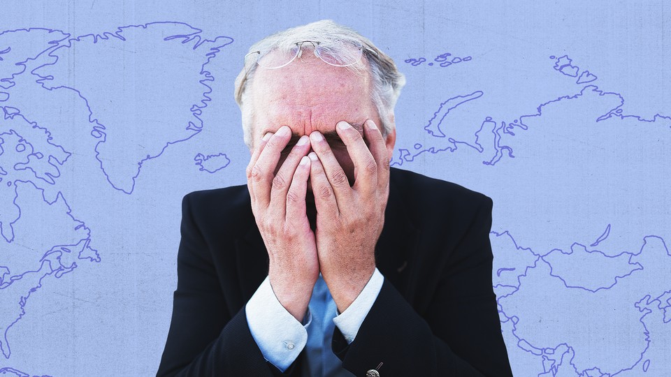 A congressman with his face in his hands and a map behind him