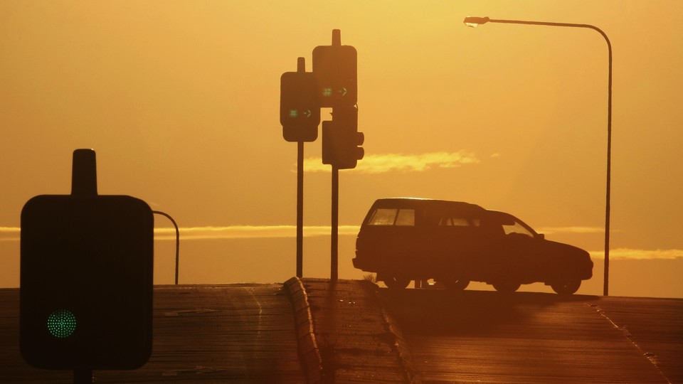 A car turns at a traffic light.