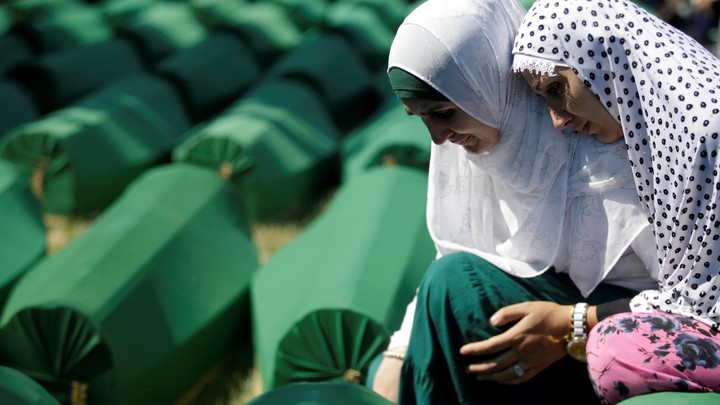 Muslim women mourn on July 11, 2016, near coffins of newly identified victims of the 1995 Srebrenica massacre.