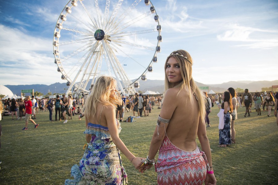 Festival goers Joy Corrigan, left, and Ashley Haas dance at the Coachella F...