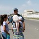 A member of Kyrgyz security forces addresses passers-by near the site of a bomb blast outside China's embassy in Bishkek, Kyrgyzstan.