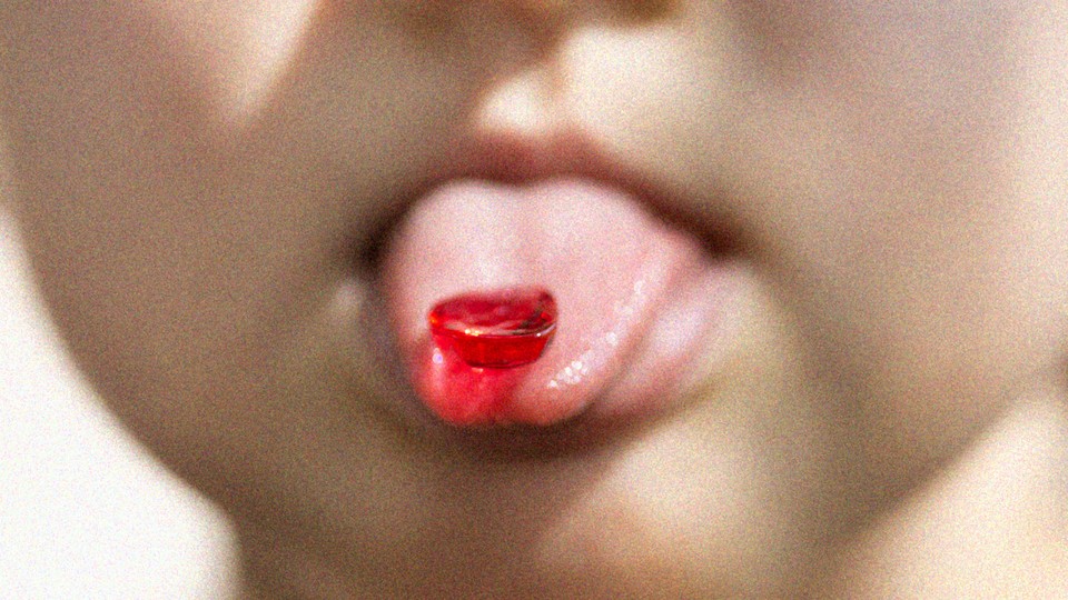 Photo of a gummy on a child's tongue