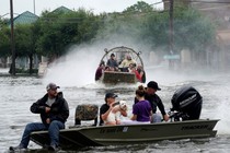 People are rescued from flood waters from tropical storm Harvey in Dickinson, Texas, on August 27, 2017.