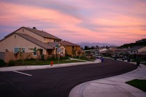 Sunset on a suburban residential block with mountains in the background