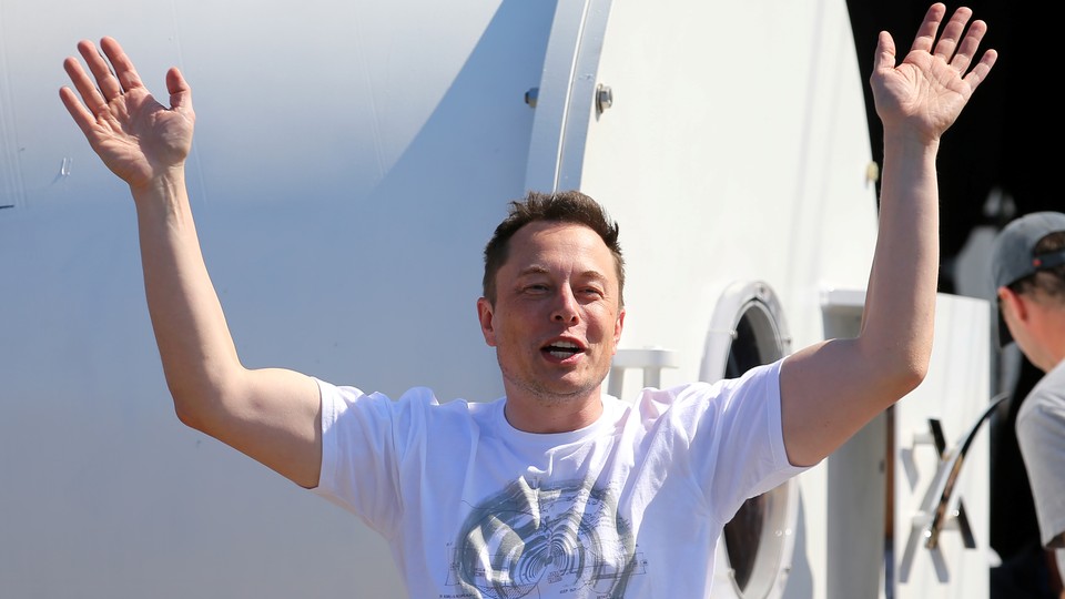 SpaceX's Elon Musk smiles and holds his hands in the air in 2017