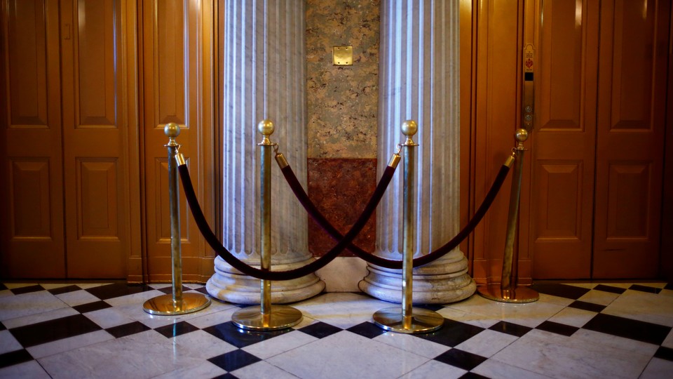 Columns, doors, and crowd-control rope barriers inside the Capitol
