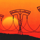 A series of electrical-transmission line towers in the shape of Tesla's logo against an orange sky