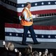 Donald Trump wears a garbage vest onstage