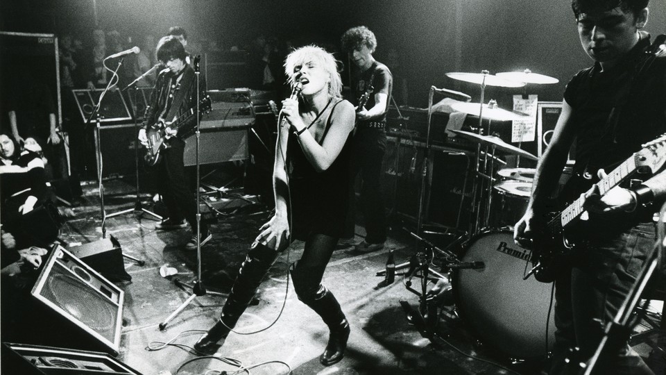 a black-and-white photo of Debbie Harry and the other members of Blondie performing onstage