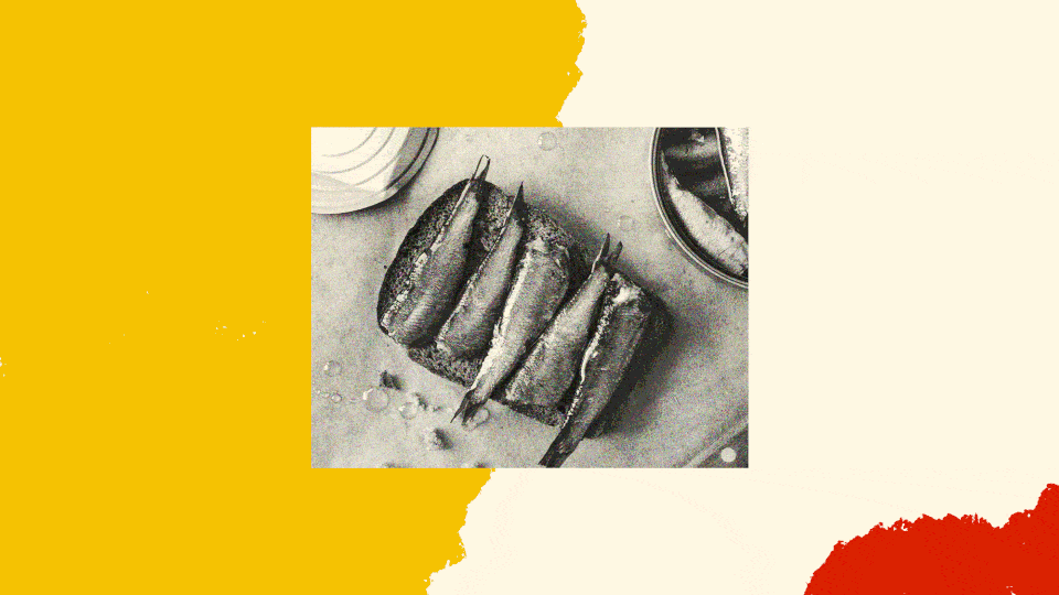 A black-and-white photo of sardines on toast.
