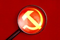 An illustration of a looking glass hovering over a Soviet hammer-and-sickle symbol