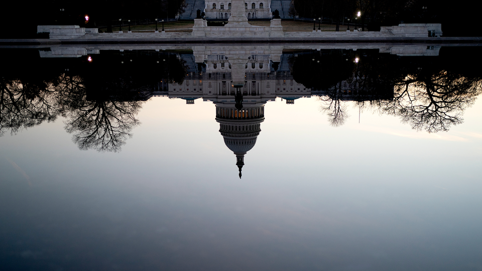 A photograph of the U.S. Capitol Building reflected upside down in the reflecting pool on the National Mall