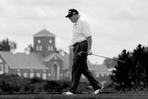 Donald Trump walks holding a golf club at his Bedminster golf club