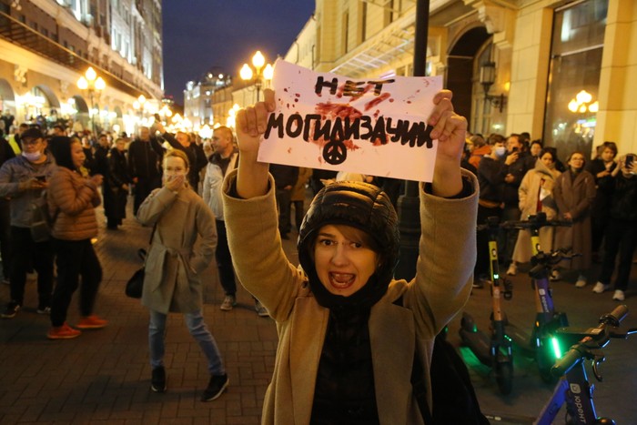 A Russian protester holding a sign that translates to No burialization in Moscow on September 21
