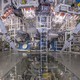 A photograph of the National Ignition Facility's target chamber, with ladders and pipes and tubes and other equipment