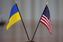 A photo of a small Ukrainian flag besides a small American one