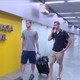 U.S. Olympic swimmers Gunnar Bentz and Jack Conger walk Wednesday to the airport police station office at Rio's international airport.