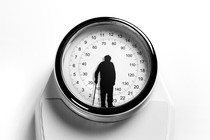 A scale overlaid with a silhouette of an older adult