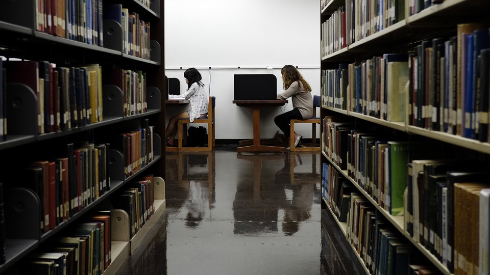 Students sit in a library.