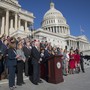 Dozens of members of Congress gather outside the Capitol building in Washington, D.C., for a press conference