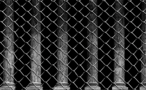 Supreme Court columns behind chain-link fence