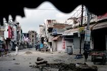 An elderly man walks in an area deserted after communal clashes in Nuh in Haryana state, India, Tuesday, Aug., 1, 2023.