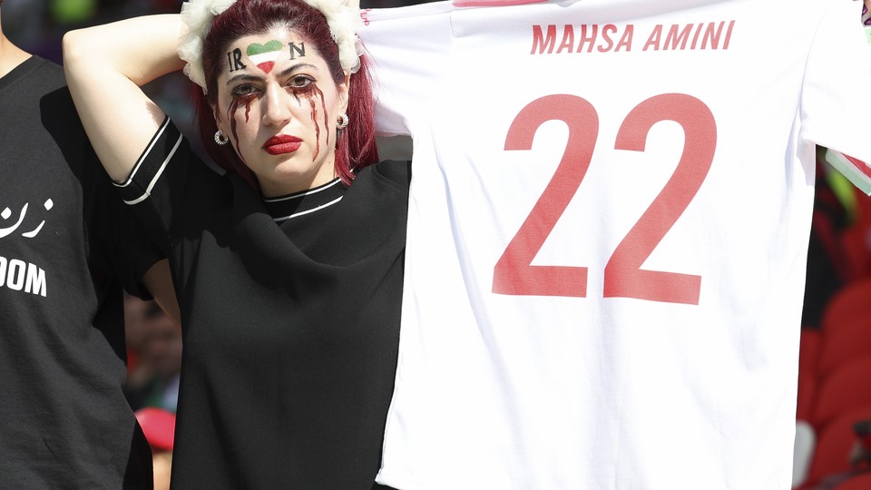 An Iran fan holds a jersey in quiet protest at the November 25 World Cup match between Iran and Wales