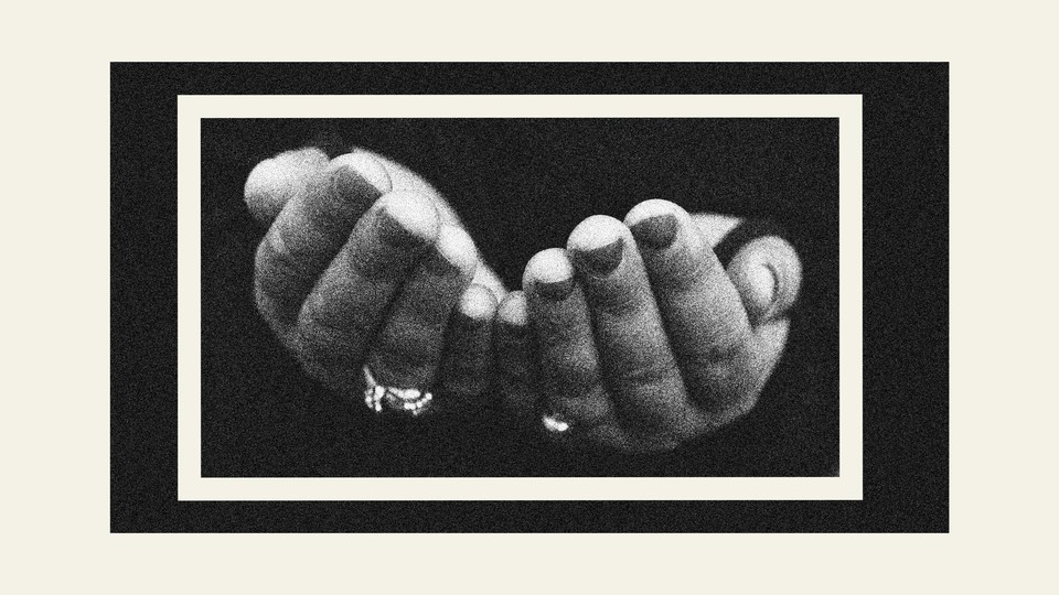 A black-and-white image of outstretched hands