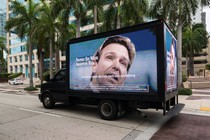 A photo of truck displaying an anti–Ron DeSantis ad