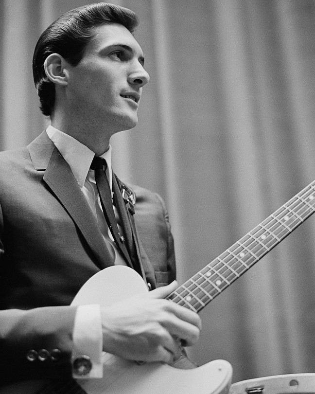 A black-and-white photo of a young Steve Cropper, in profile, holding his guitar