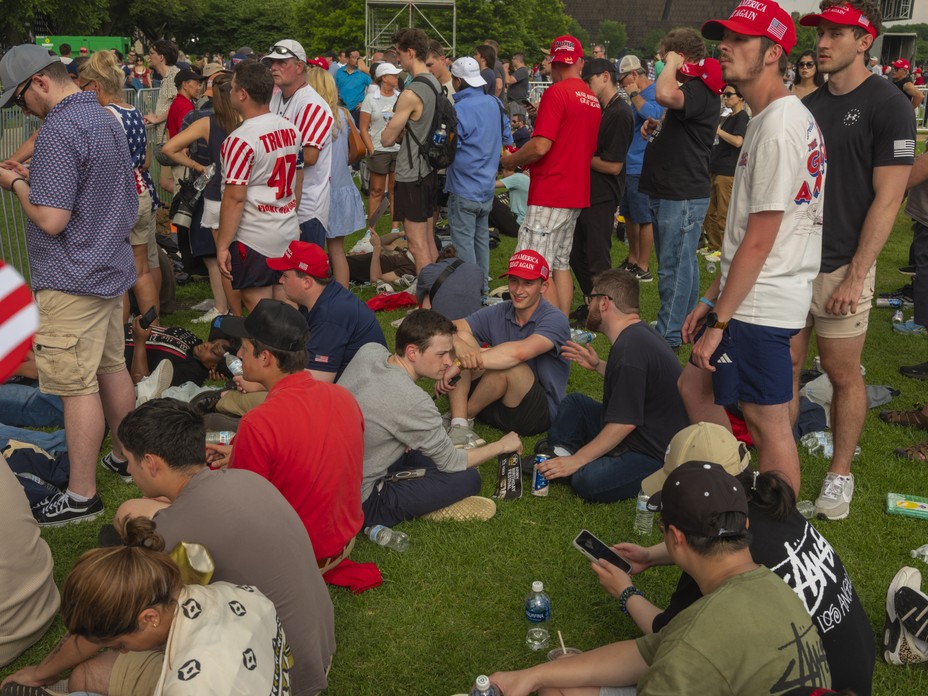 Picture of onlookers waiting for a glimpse of President Trump, who watched the parade from a stage south of the White House.