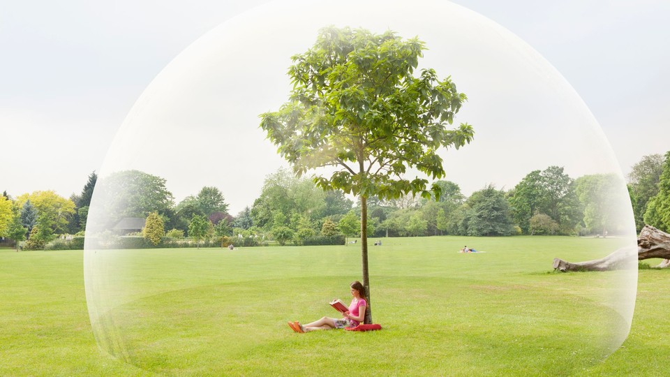 Woman reading a book by a tree, surrounded by a bubble