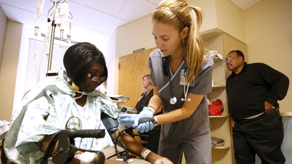 Nurse checks patient's vitals