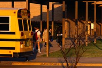 Students get off a school bus.