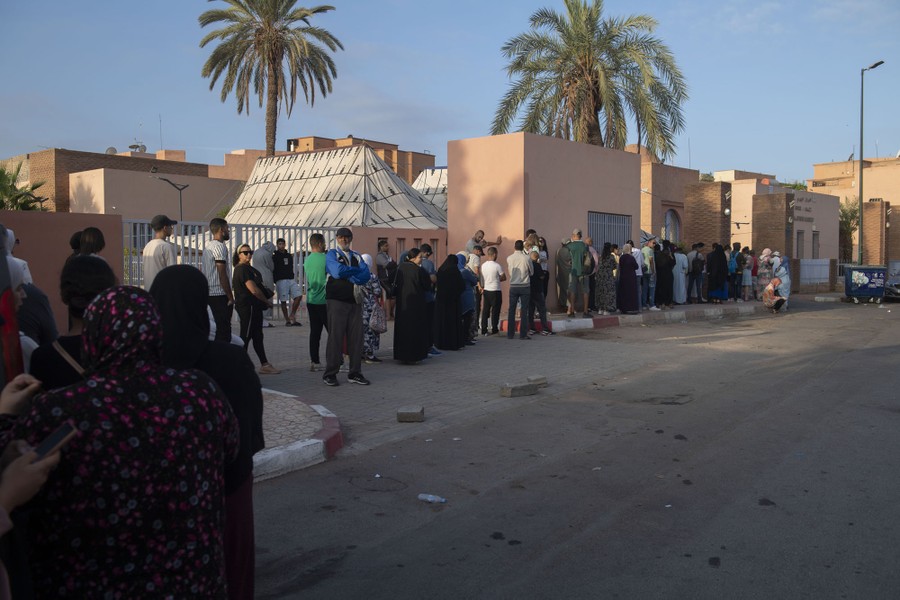 People line up outside a clinic to donate blood.