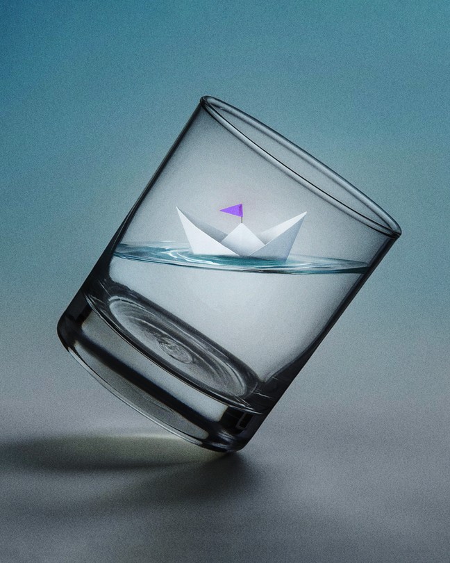 a level boat inside a sharply tilted glass