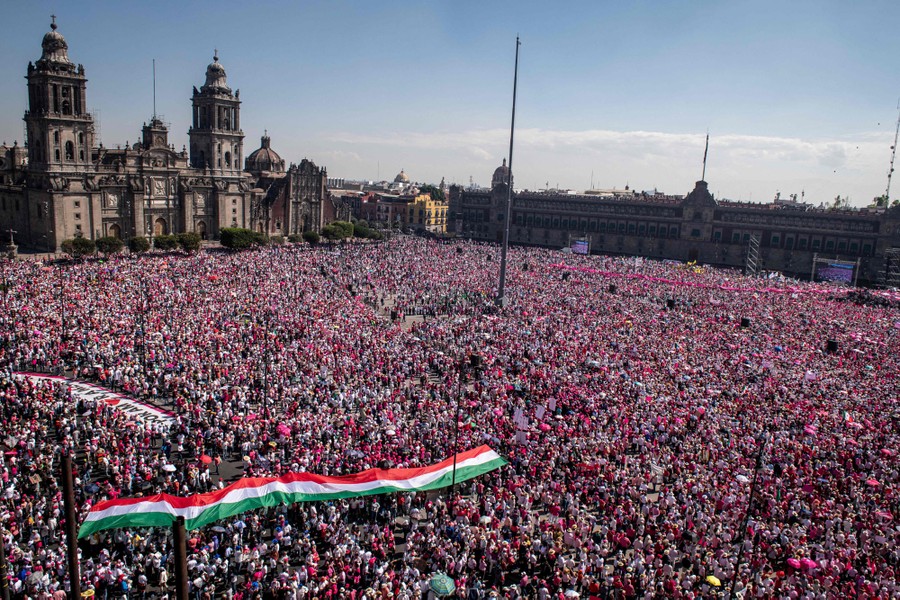 A huge crowd of protesters gathers in a square in Mexico City.