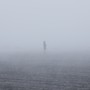 A woman walking in the mist