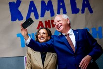 Kamala Harris and Tim Walz smile for a selfie