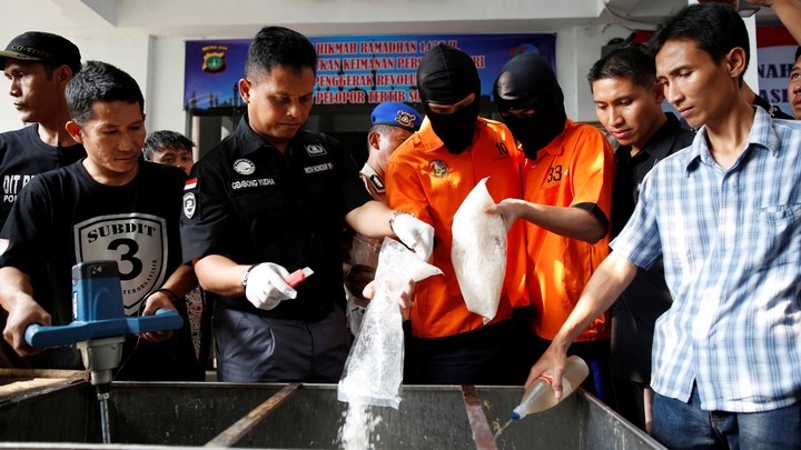 Recently arrested drug trafficking suspects are forced to take part in the destruction of illegal narcotics in Indonesia.