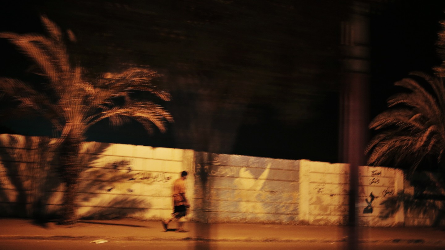 Man walks at night, in Aden, Yemen, February 10, 2018.