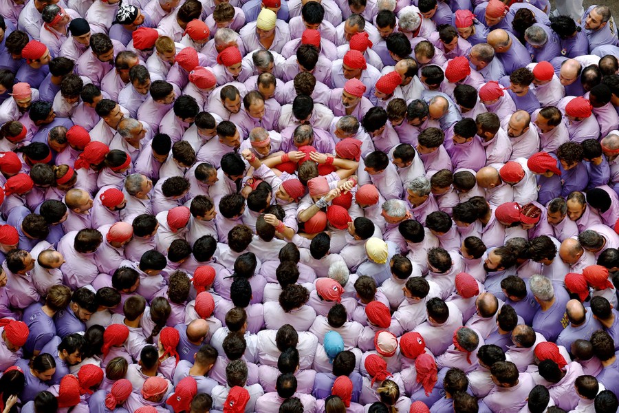 An overhead view of many people crowding around around a person in the center
