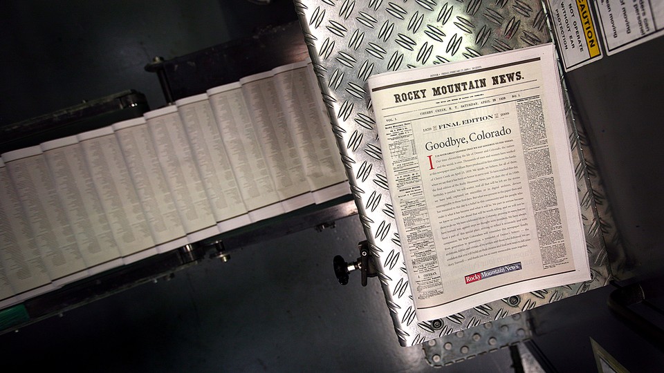 A final edition of the Rocky Mountain News sits atop a piece of the presses on February 26, 2009
