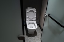 A photo of a toilet with the lid up