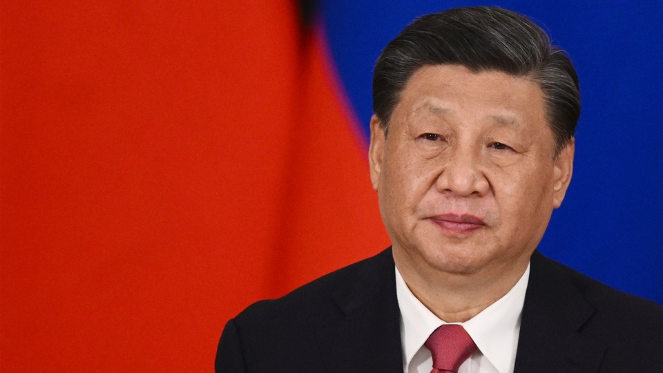 Close-up of Xi Jinping against a red-and-blue field
