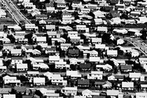 Black-and-white aerial photo of detached, suburban homes