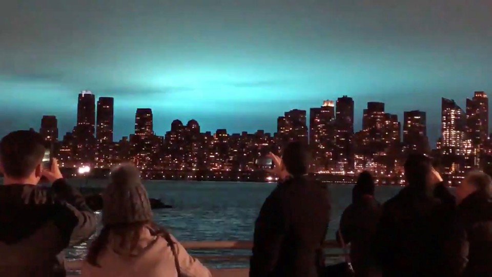 Blue light illuminates the night sky over New York City after a transformer explosion.