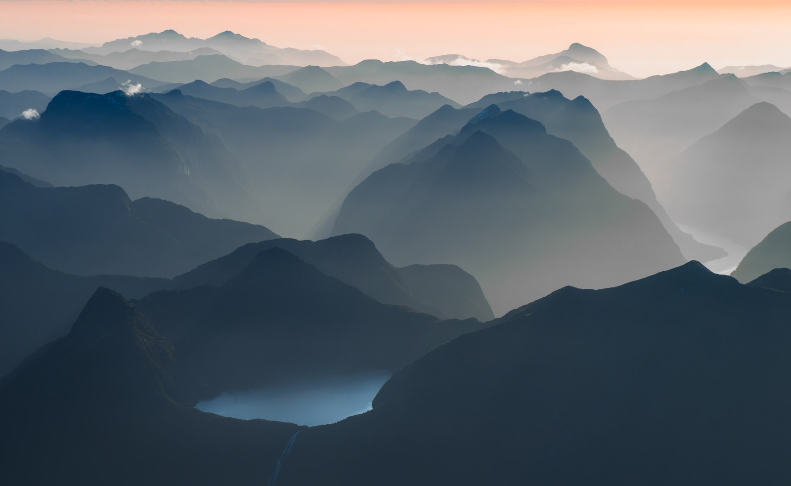 A landscape view of many mountains and mist-filled valleys.